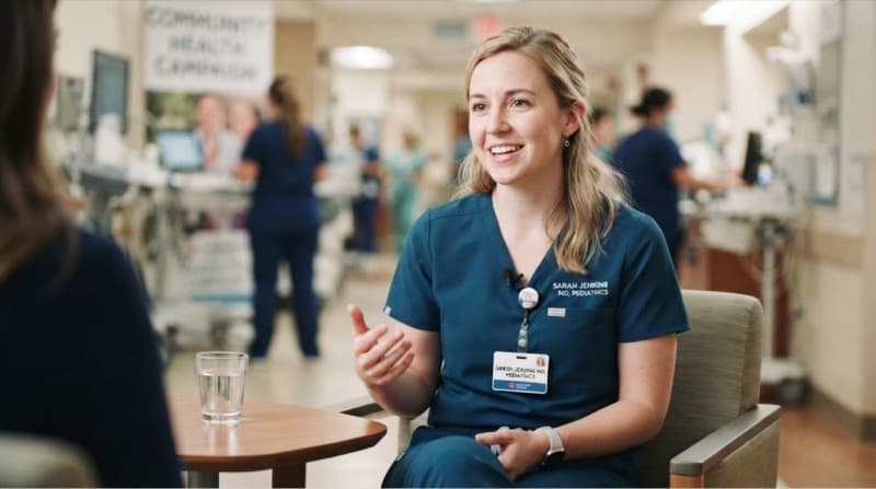 Smiling female doctor in navy scrubs