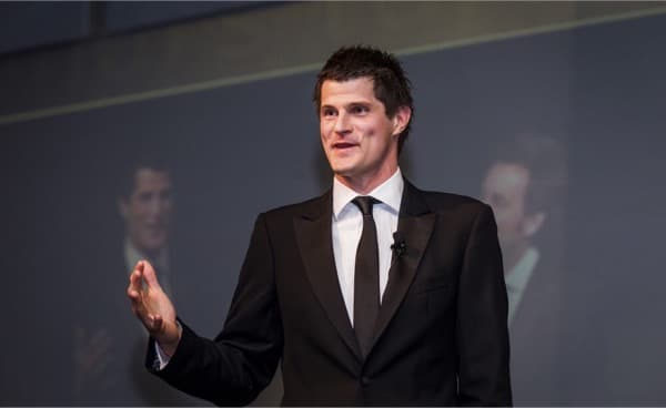 Dr Sam Hazledine speaking on stage